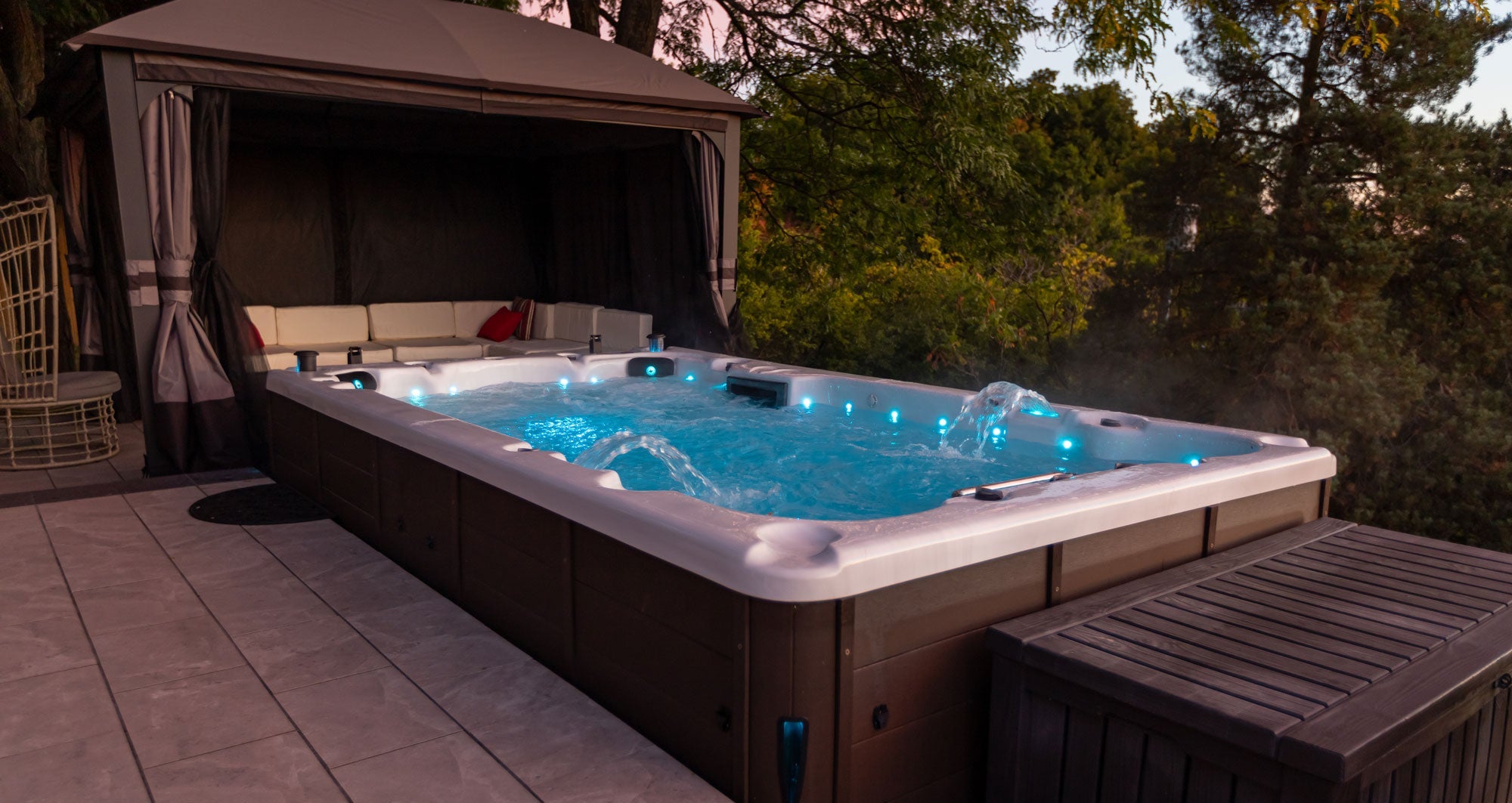13ft St Lawrence Swim Spa outside with outdoor patio seating behind it